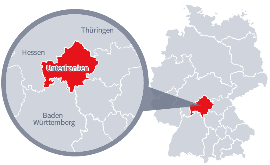 Diese Grafik zeigt eine Karte von Deutschland mit einer detaillierten Ansicht der Region Unterfranken. Unterfranken ist in Rot hervorgehoben und liegt im südlichen Teil Deutschlands. Ein Lupensymbol vergrößert diesen Bereich, um die Lage genauer darzustellen. 